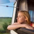 Woman looking out the window of her Prius Camper.