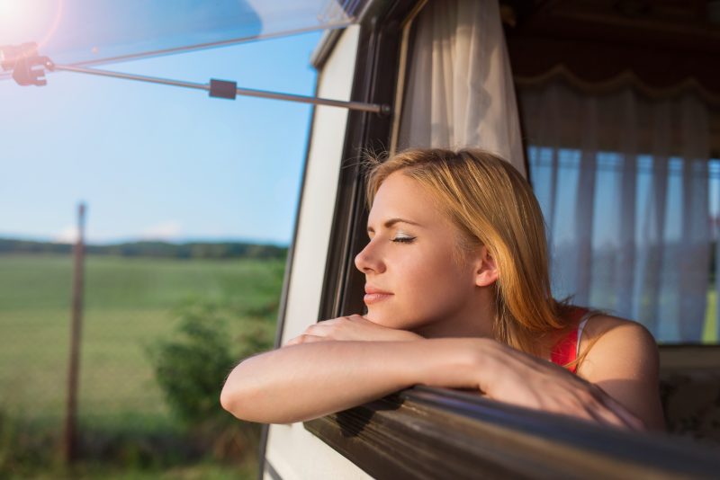 Woman looking out the window of her Prius Camper.