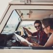 Man and woman preparing to drive through mountains.
