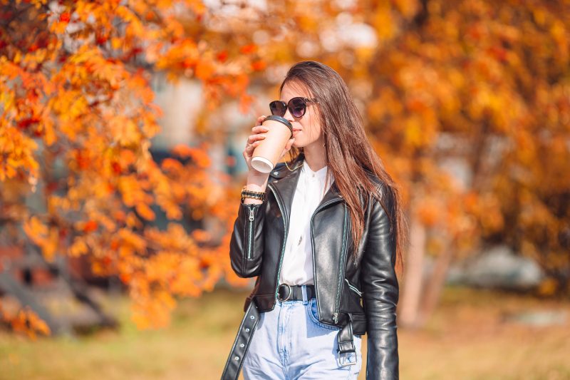 Woman drinking coffee during the Fall.