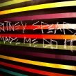 Graffiti in Arizona that reads "Britney Spears Made Me Do It" on a colorful striped wall.