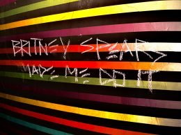 Graffiti in Arizona that reads "Britney Spears Made Me Do It" on a colorful striped wall.