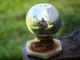 Close up of a weather hitch ball reflecting camera man in metal.