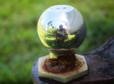 Close up of a weather hitch ball reflecting camera man in metal.