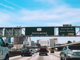 Green road sign over the highway directing drivers to Hollywood.
