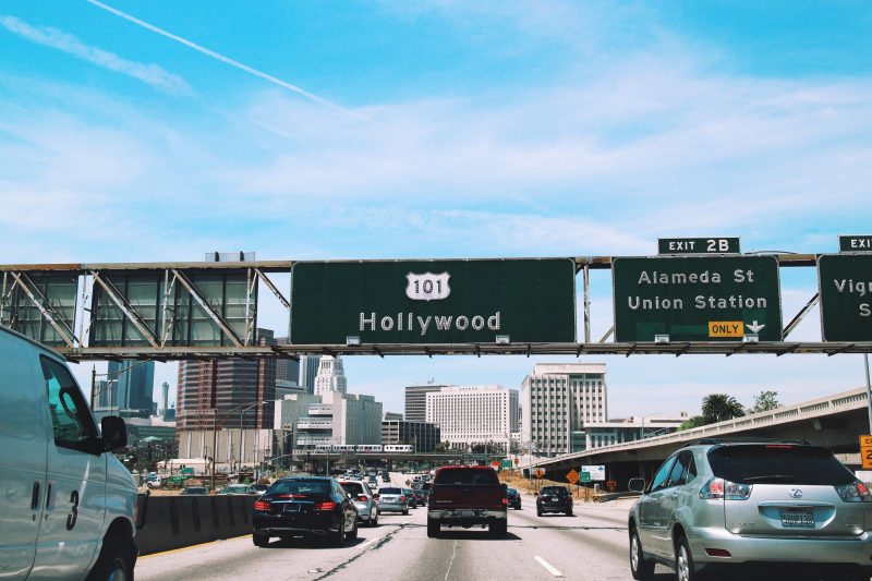 Green road sign over the highway directing drivers to Hollywood.