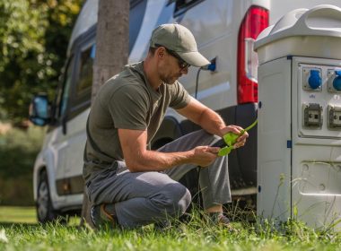 Man inspects the electric plug connection for his RV.