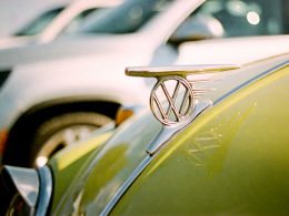VW hood ornament on a bright green bug.
