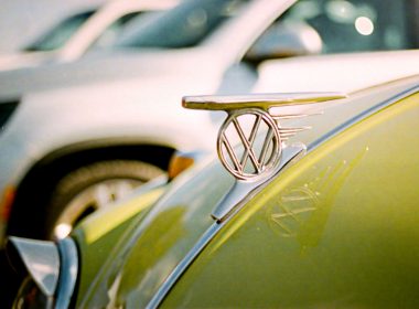 VW hood ornament on a bright green bug.