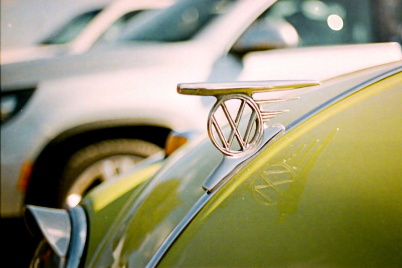 VW hood ornament on a bright green bug.