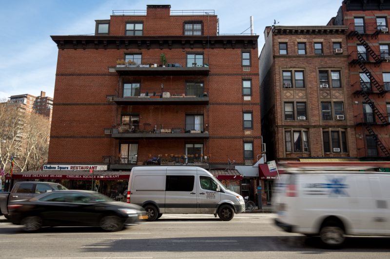 A van in an urban setting camping on the street.