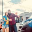 A couple embraces and shops in a RV dealer parking lot