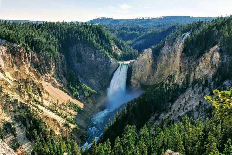 View over the landscape in Yellowstone National Park of a waterfall.