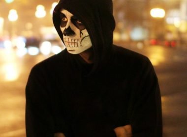 cropped-halloween-a-man-with-a-mask-on-his-face-walking-the-city-at-night-halloween-man-costume-evil-holiday_t20_z9drzQ.jpg