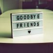 A sign that says goodbye friends with a heart shape.