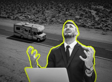 A man throws his hands up in distress at his computer.
