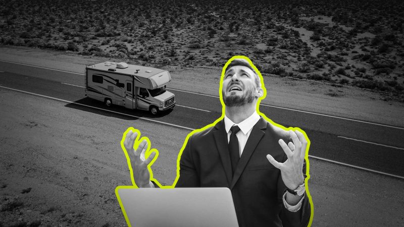 A man throws his hands up in distress at his computer.