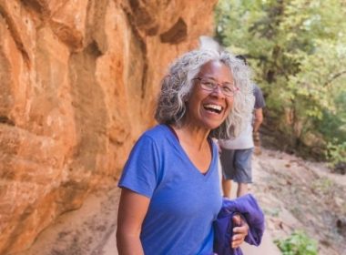 An athletic senior woman living an adventure while hiking in Utah.