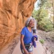 An athletic senior woman living an adventure while hiking in Utah.