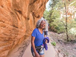 An athletic senior woman living an adventure while hiking in Utah.