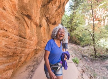 An athletic senior woman living an adventure while hiking in Utah.