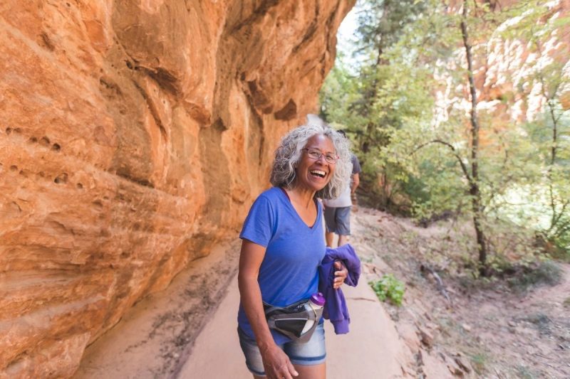 An athletic senior woman living an adventure while hiking in Utah.