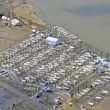 Aerial view of a packed campground next to a dirty river.
