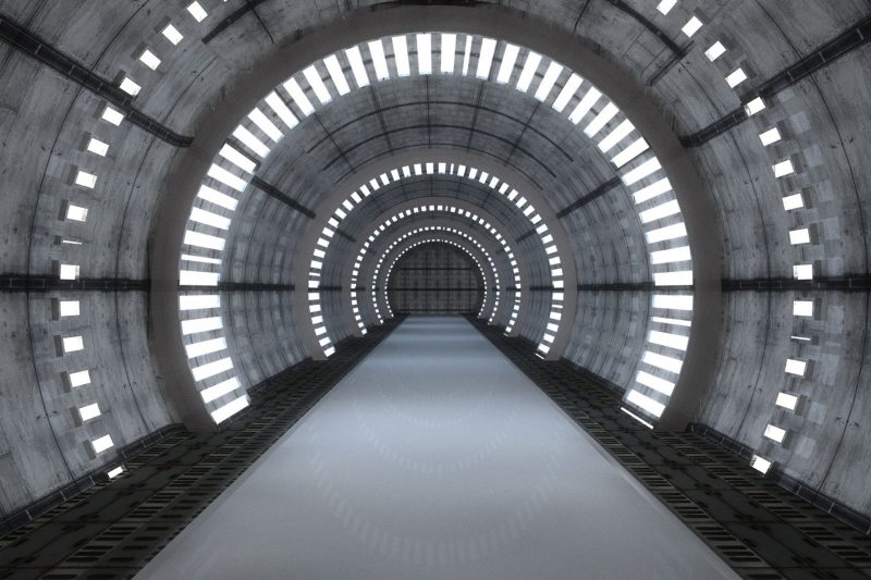 An underground futuristic tunnel with lights.