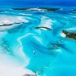 From high above, turquoise blue waters shine brilliantly in the sun along the Exuma Islands in the Bahama.