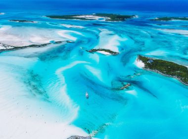 From high above, turquoise blue waters shine brilliantly in the sun along the Exuma Islands in the Bahama.