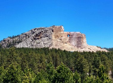 A portrait view of the partially completed Crazy Horse Memorial statue in the Black Hills.
