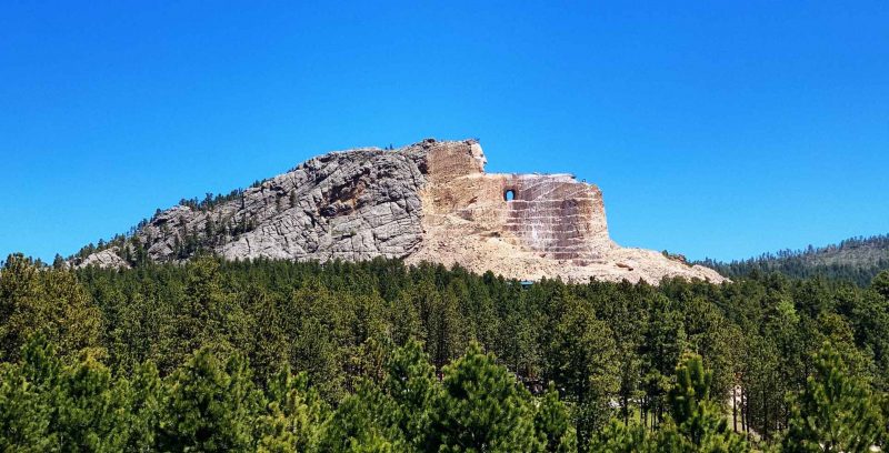 A portrait view of the partially completed Crazy Horse Memorial statue in the Black Hills.