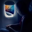 A futuristic travel photo of a woman flying high above a planet from a commercial space ship.