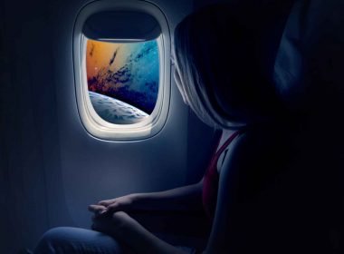 A futuristic travel photo of a woman flying high above a planet from a commercial space ship.