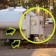 A fifth wheel with its slide extended in a campground.