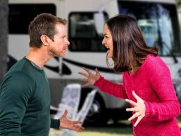 A couple arguing outside of an RV