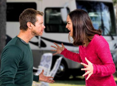 A couple arguing outside of an RV