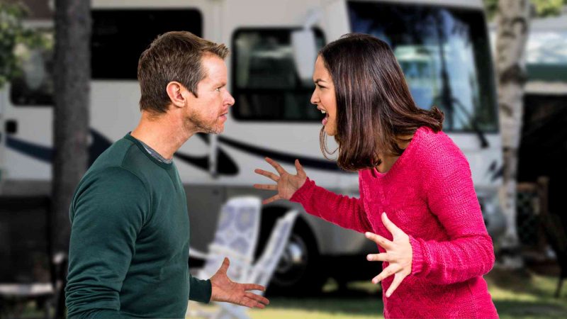 A couple arguing outside of an RV