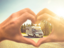 Hands making heart around RV