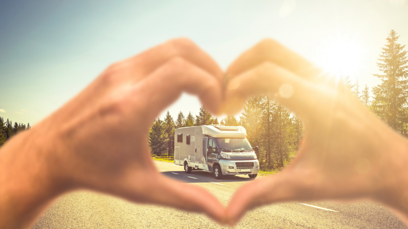 Hands making heart around RV