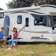 RV couple happily in front of RV