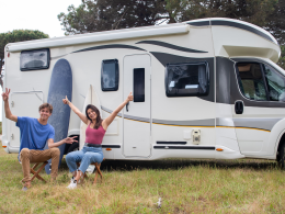 RV couple happily in front of RV