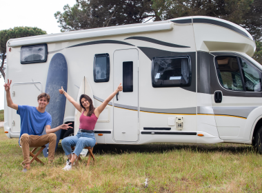 RV couple happily in front of RV