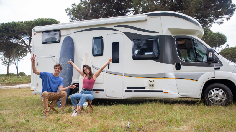 RV couple happily in front of RV