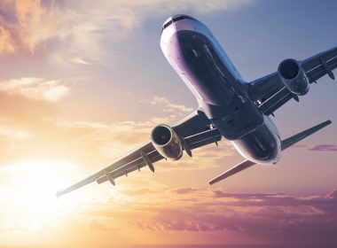 Airplane flying at sunset