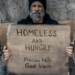 Homeless man holding sign