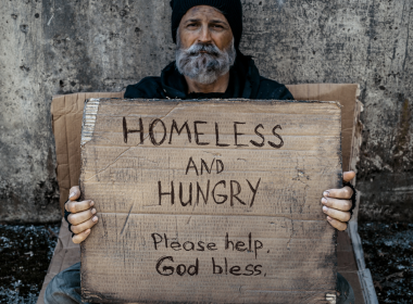 Homeless man holding sign