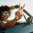 Woman happily driving on a road trip