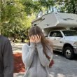 A couple fighting while standing outside of their RV.