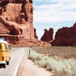 A camper van driving down the highway during a road trip.
